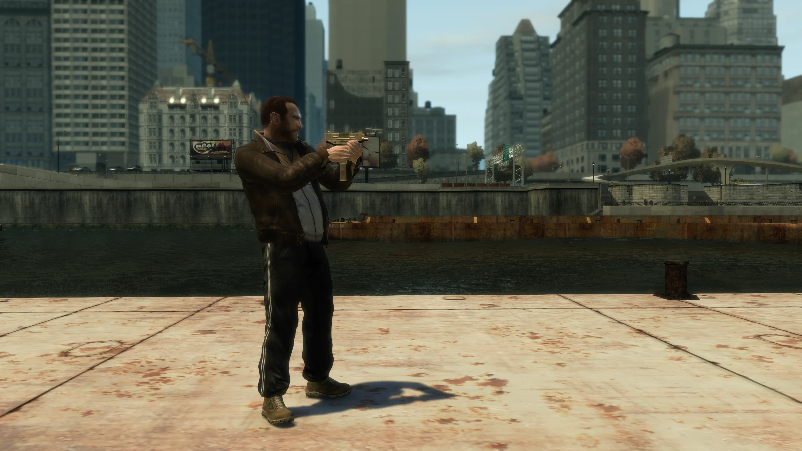 A screenshot of Niko holding the Uzi SMG in GTA IV. On PC he holds it closer to his body.